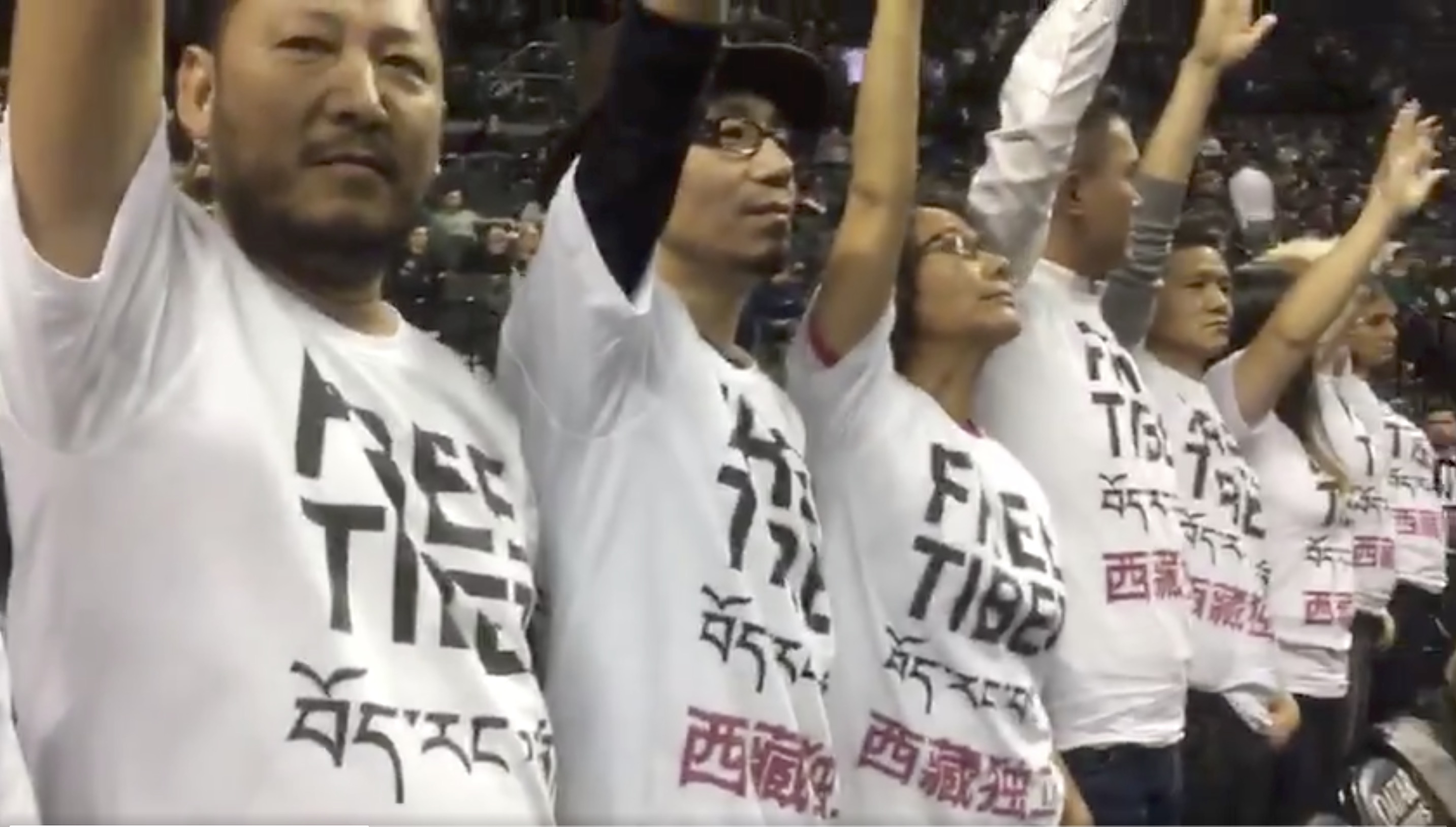 Protestors wearing T-shirt calling for Free Tibet in English, Tibetan and Chinese at the Nets vs. Raptors NBA game at Barclay Center on Friday night