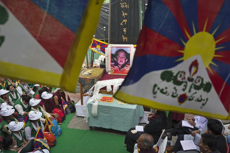A portrait of the 11th Panchen Lama is seen as exile Tibetans mark his birthday in Dharmshala in April 2019 (AP Photo-Ashwini Bhatia)